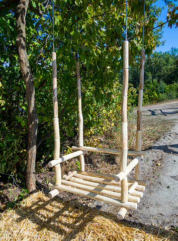 Homemade swing from wooden poles.