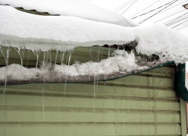 istock Gutter broken by snow masses sliding from the roof 1932861535