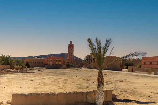 Esplanade and view of minarets of mosques in the background in Erfoud, Morocco