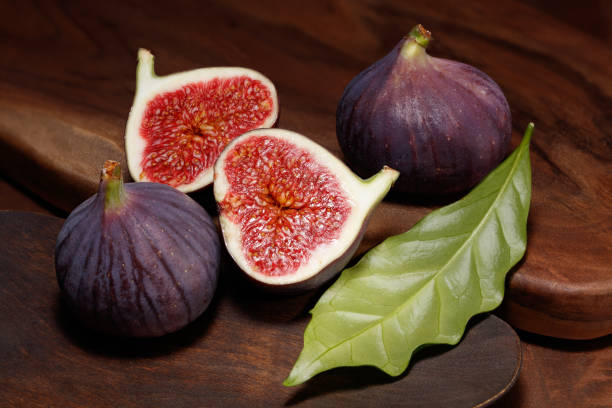 istock Sliced few figs on a wooden background. 1932908781