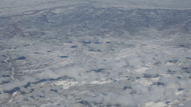 Flying over North America during winter season. Landscape from the window of the airplane