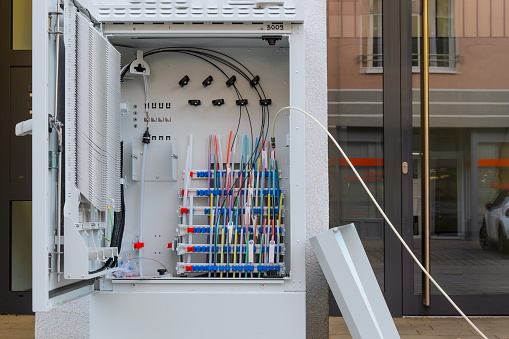 Fiber optic cable distribution cabinet. It is open and you can see the colored fiber inside