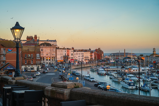 Ramsgate, UK - Dec 17 2023 Ramsgate Royal Harbour and its historic buildings catching the colours of the setting sun.