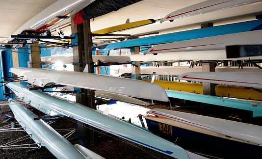 Rowing boats, kayak and canoe storage room. Rowing equipment\n\nIn addition to rowing boats, you'll also find rowing equipment, such as oars, rowing shoes, boat trailers or cox boxes,- stock photo