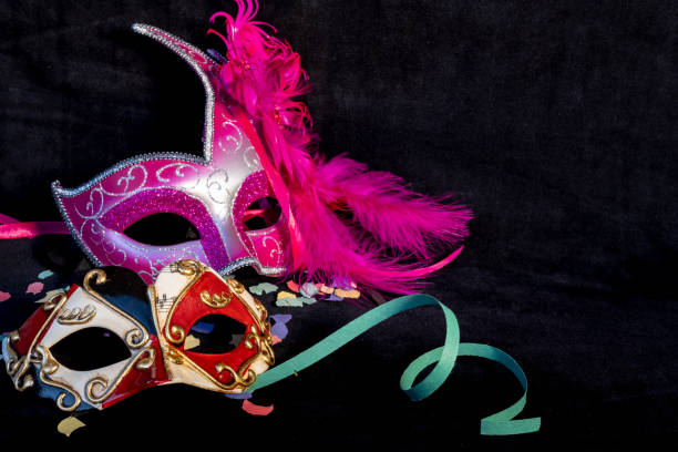 istock 2 carnival Venecia masks on black background 1932997338