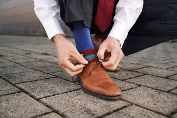istock Hands of a manager lacing his shoes 1933004769