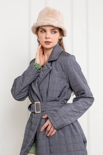 istock Blonde young woman wearing gray coat. 1933004774