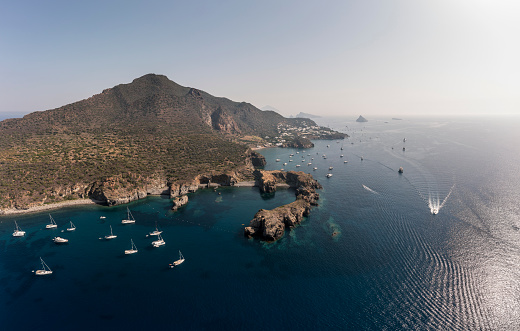 Classical sailing yard in Panarea Caletta dei Zimmari Aeolian Islands in Summer with many boats anchored in Paradies anchor place