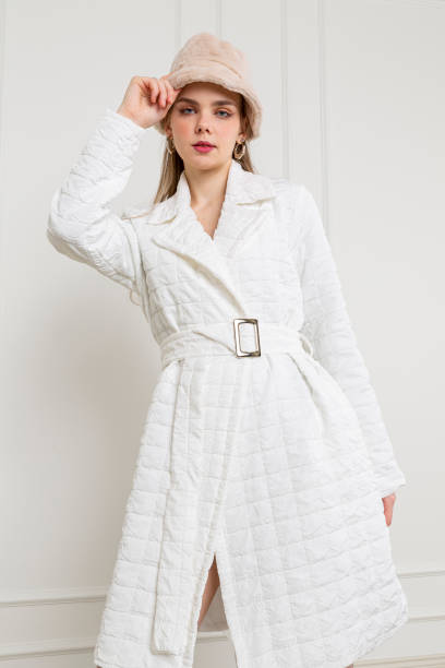 istock Blonde young woman wearing white coat. 1933007874