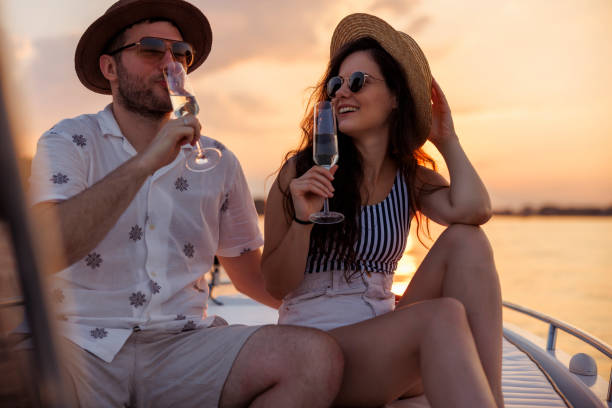 istock Couple drinking champagne while sailing to the sunset on a boat 1933016207