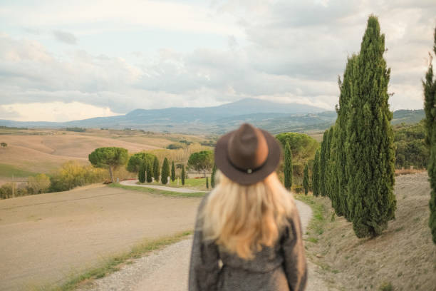 istock Young woman walks down country road 1933019353