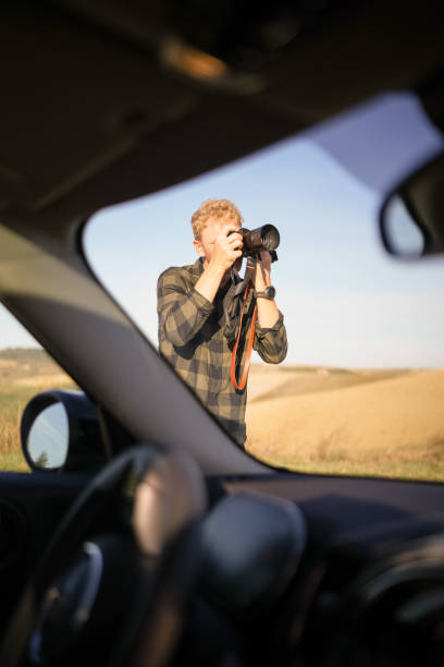istock Photographer explores Tuscan countryside 1933019357