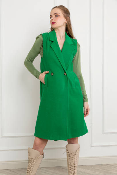 istock Blonde young woman wearing green jacket. 1933028943