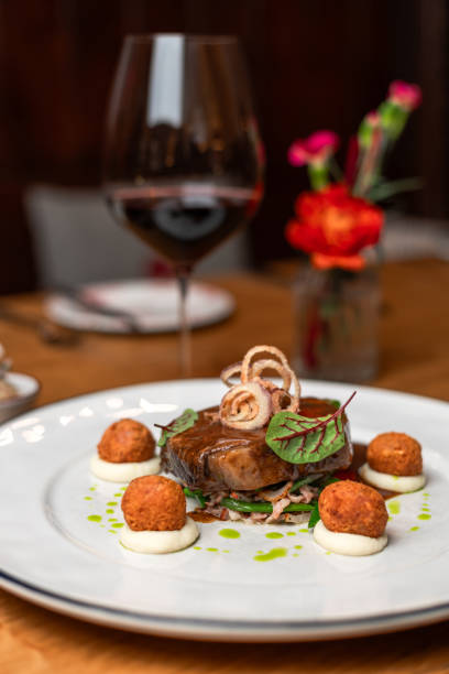 beef deer steak filet with fried sweetbread and gravy served with red wine at michelin star gourmet restaurant - steak filet mignon elegance restaurant zdjęcia i obrazy z banku zdjęć