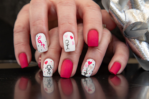 Fashionable aquarium French manicure on long rounded nails with sequins of different sizes.