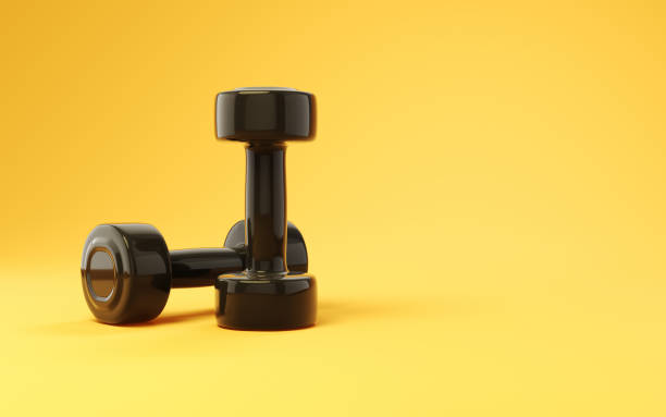 Golden fitness dumbbells. Isolated on the white background