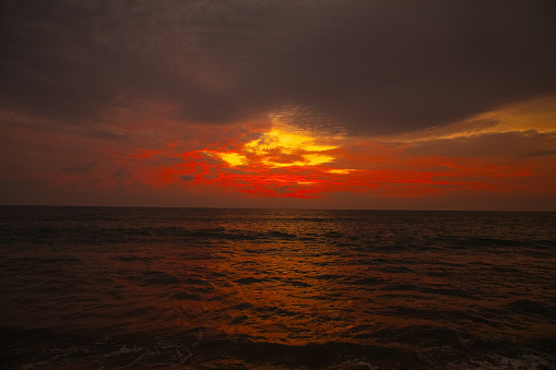 Sunset near famous tourist landmark of Bali island - Wide Angle view of tropical beach sea at sunset in Bali Island