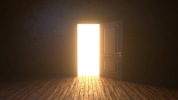 istock Light shines from door opening in dark room 1933092569