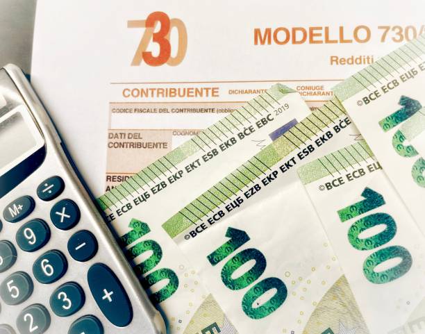 province of florence , january 14th 2024, many euro banknotes with the modello 730 as background , translating in italian as declaration of incomes , concept of tax payment . - incomes - fotografias e filmes do acervo