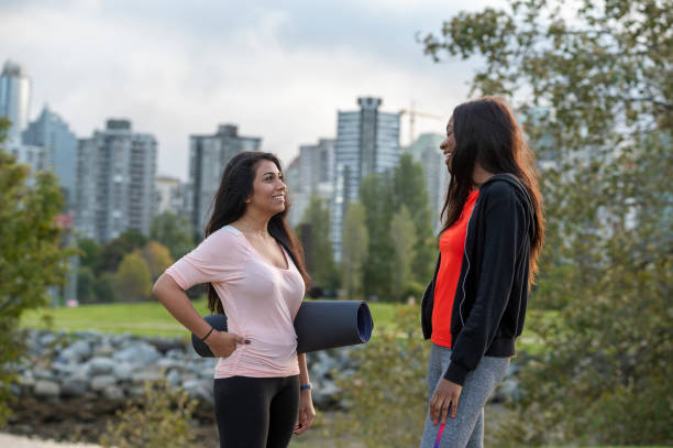 istock Young women walk home from yoga class together 1933105582