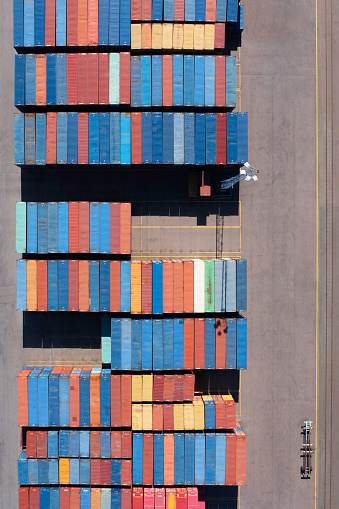 Aerial view of colorful rows of cargo containers in a harbor.