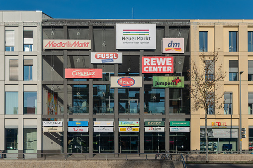Neumarkt, Germany - January 11, 2024: Shopping center in the Bavarian town Neumarkt with stores, restaurants and service areas. Advertising, logos and brand names on the facade. Opening in 2015. Large retail chains such as MediaMarkt, Rewe, dm, Hervis, TEDI etc. are represented here.