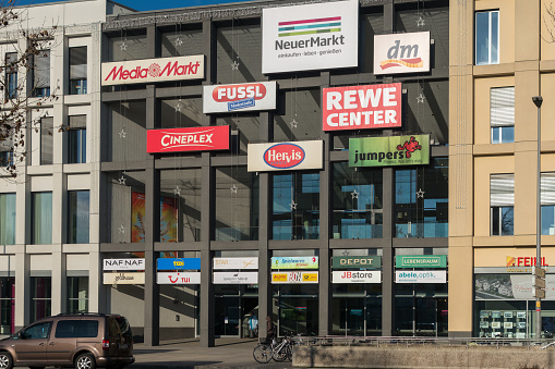 Neumarkt, Germany - January 11, 2024: Shopping center in the Bavarian town Neumarkt with stores, restaurants and service areas. Advertising, logos and brand names on the facade. Opening in 2015. Large retail chains such as MediaMarkt, Rewe, dm, Hervis, TEDI etc. are represented here.