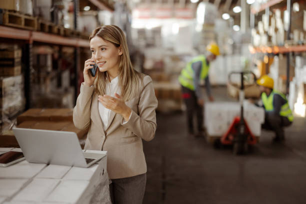 istock Female Manager Talking on a Mobile Phone at Warehouse 1933192518