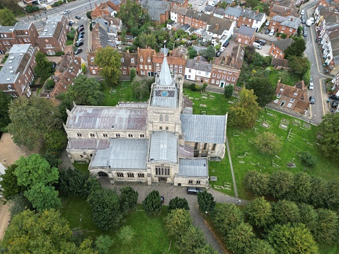 A drone image of St Mary the Virgin Church in Aylesbury, England showing church and surrounding buildings and graveyard