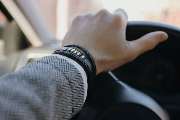 istock Classical male leather bracelet on a hand in the car 1933231183