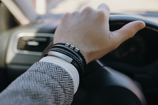 A leather bracelet on the male driver hand