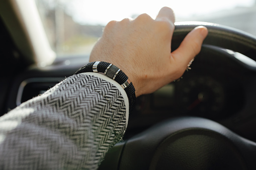 A leather bracelet on the male driver hand