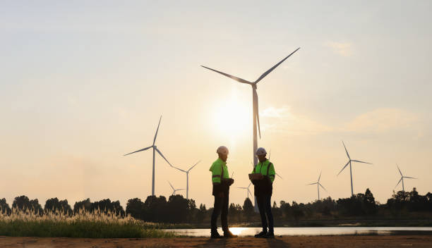 istock Silhouette engineer working at the windmill field. windmills are ecology energy renewable  alternative green power environment factory 1933258490