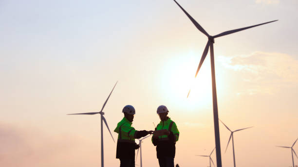 istock Silhouette engineer working at the windmill field. windmills are ecology energy renewable  alternative green power environment factory 1933258491
