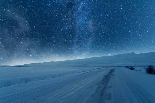istock Beautiful night landscape. Snow covered mountains under beautiful bright Milky Way Galaxy. 1933272172