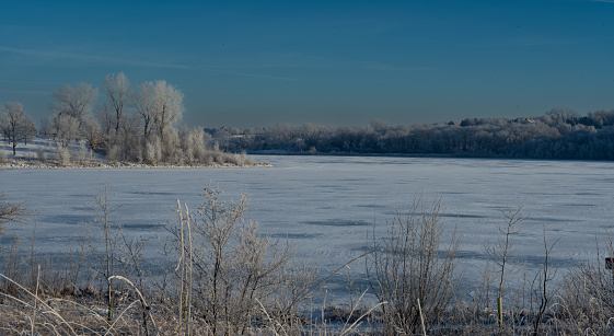 Winter's landscape with a beautiful view of a lake.