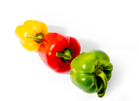 Three bell peppers, red pepper , green pepper and yellow pepper on the white background. Colorful paprika. Product photography.