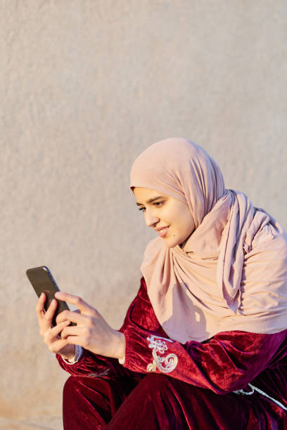 istock Young arabic woman using mobile phone 1933357848