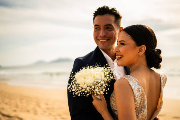 istock Bride and groom embraced on the beach 1933359976