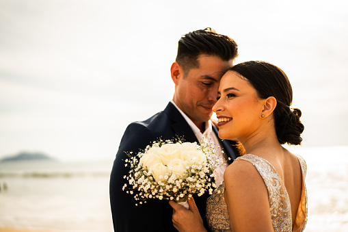 Bride and groom together on the beach