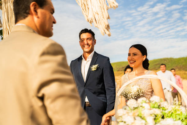 istock Bride and groom in wedding ceremony on the beach 1933361597