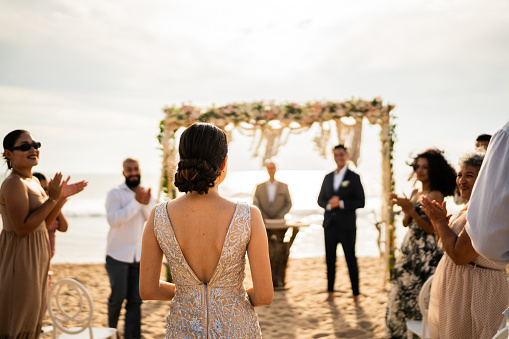 Bride entering wedding on the beach