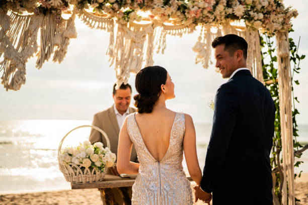 istock Bride and groom in wedding ceremony on the beach 1933361614