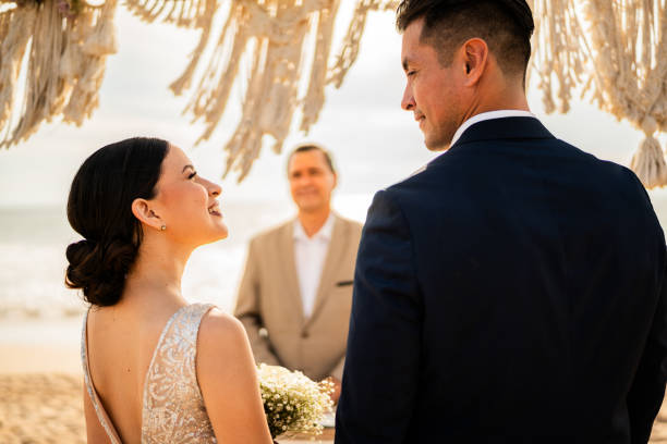 istock Bride and groom in wedding ceremony on the beach 1933361631