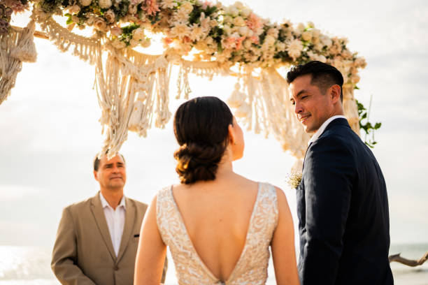 istock Bride and groom in wedding ceremony on the beach 1933362144
