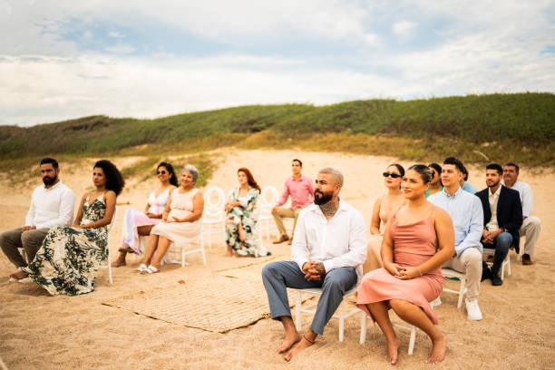 istock Wedding guests watching the ceremony on the beach 1933363211