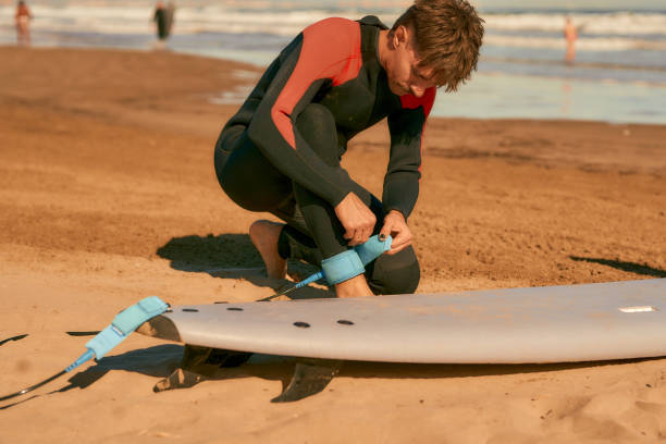 istock Surfer in wetsuit with surfboards is preparing for ride on waves 1933367934