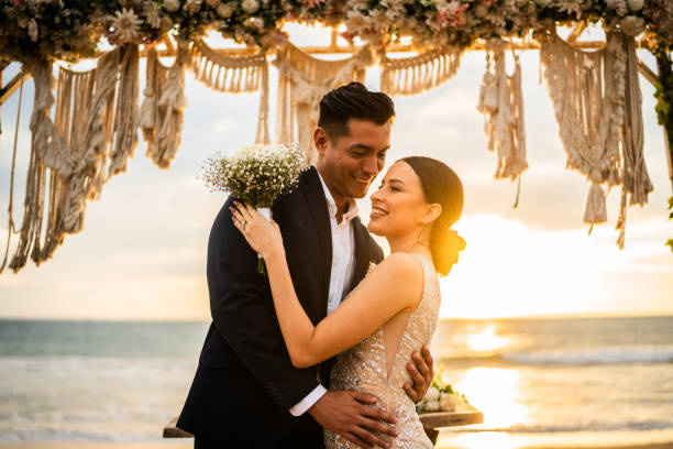 istock Bride and groom in wedding ceremony on the beach 1933373594