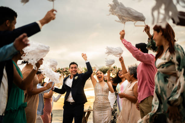 istock Newlyweds celebrating with their guests at beach wedding ceremony 1933374116