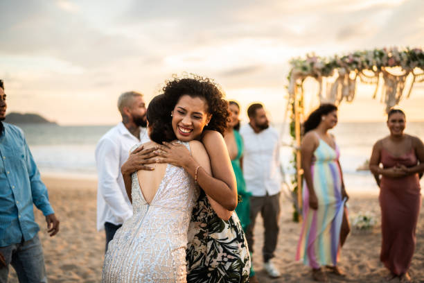 istock Bride embracing her friend after wedding ceremony on the beach 1933374640